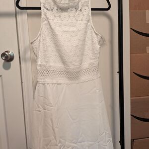 White lace dress with floral embroidery and a fitted silhouette